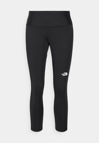 Leggings atletici neri con vita alta, realizzati in un tessuto liscio ed elastico. Presentano un piccolo logo bianco sulla parte inferiore della gamba sinistra.