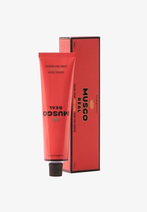 Rotes Aluminiumrohr mit schwarzem Verschluss, mit "MUSGO REAL" in Gold beschriftet. Dazu passende rote Box mit schwarzen Akzenten. 100 ml.