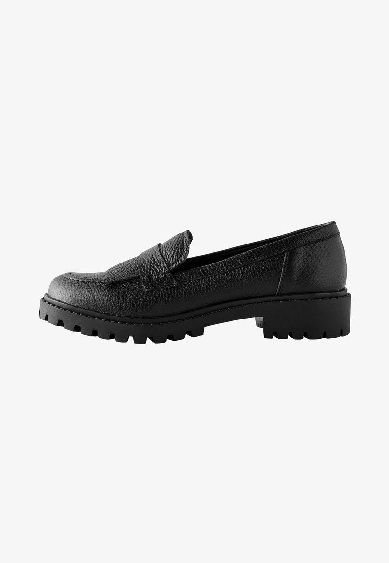 Black leather loafers feature a textured surface, a slip-on design, and a chunky, ridged sole for enhanced traction.