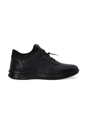 Black leather sneaker with a smooth finish, lace-up design, padded collar, and textured sole. Features a red accent on the tongue.