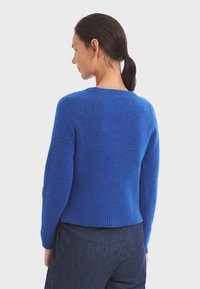 Bright blue knitted sweater with ribbed hem and cuffs; features a rounded neckline and a plush texture, suitable for casual wear.