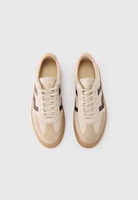 Beige sneakers with suede and leather upper. Brown side stripes and light pink accents. Round toe and flat gum sole with lace closure.
