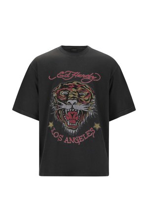 T-shirt oversized nera con una grafica di tigre multicolore, dettagli intricati, testo ricamato e stelle, realizzata in tessuto di cotone.