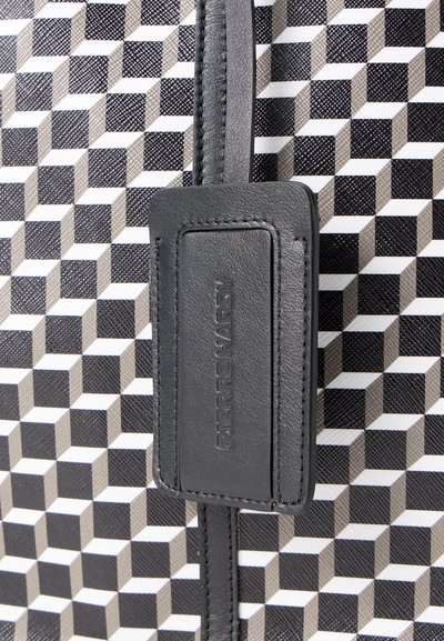 Black and white patterned bag featuring a 3D cube design, textured synthetic material, and a black leather tag with embossed lettering.