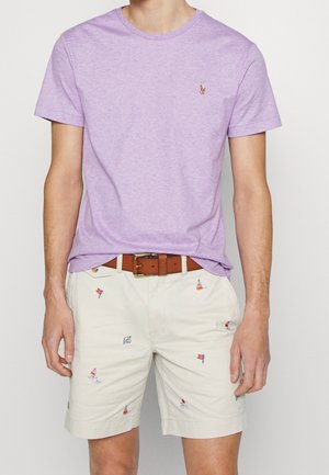Lavender crewneck t-shirt paired with khaki shorts featuring colorful sailboat embroidery, complemented by a brown leather belt.