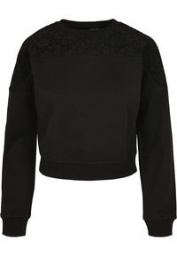 Sweat-shirt court noir à manches longues avec détails en dentelle florale sur le haut de la poitrine et les épaules, poignets et ourlet côtelés.