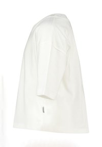 White cotton t-shirt with short sleeves, relaxed fit, and side seam label. Smooth texture and standard crew neck design.