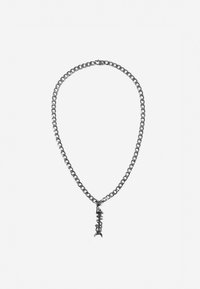 Collar de cadena de plata con eslabones grandes y un colgante en forma de espina de pescado con detalles texturizados. Acabado metálico suave en toda su superficie.