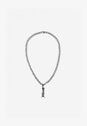 Collar de cadena de plata con eslabones grandes y un colgante en forma de espina de pescado con detalles texturizados. Acabado metálico suave en toda su superficie.