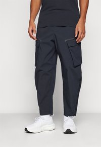 Under Armour UNSTOPPABLE - Hlače za otvoreno - black