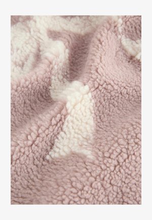 Soft fleece blanket featuring a textured, plush surface in pale pink with cream accents, displaying a subtle pattern.