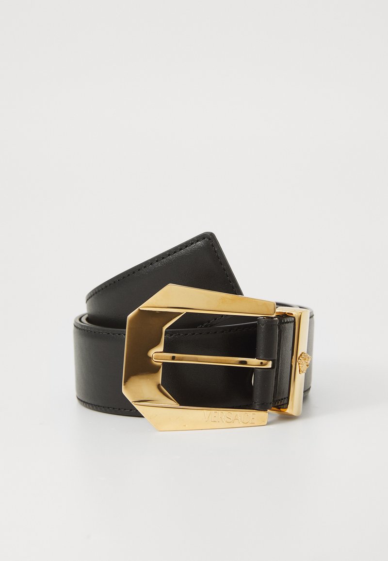 Black leather belt with a large, angular gold buckle engraved with "Versace" and a small Medusa head detail.