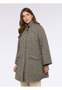 Cappotto intrecciato in tonalità grigie e beige, con colletto alto, grandi bottoni grigi, due tasche frontali e una silhouette ampia a forma di A.