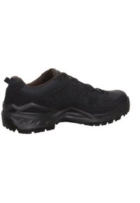 Black hiking shoe featuring a combination of suede and mesh materials, textured surface, and a rugged, multi-patterned rubber sole.