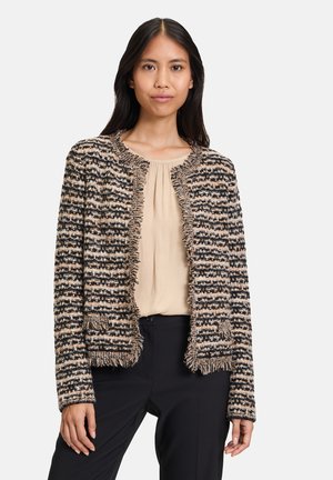 Gestreifter Tweed-Blazer in Schwarz, Beige und Creme, mit Fransen entlang der Kanten, zwei Vordertaschen und ohne Kragen.