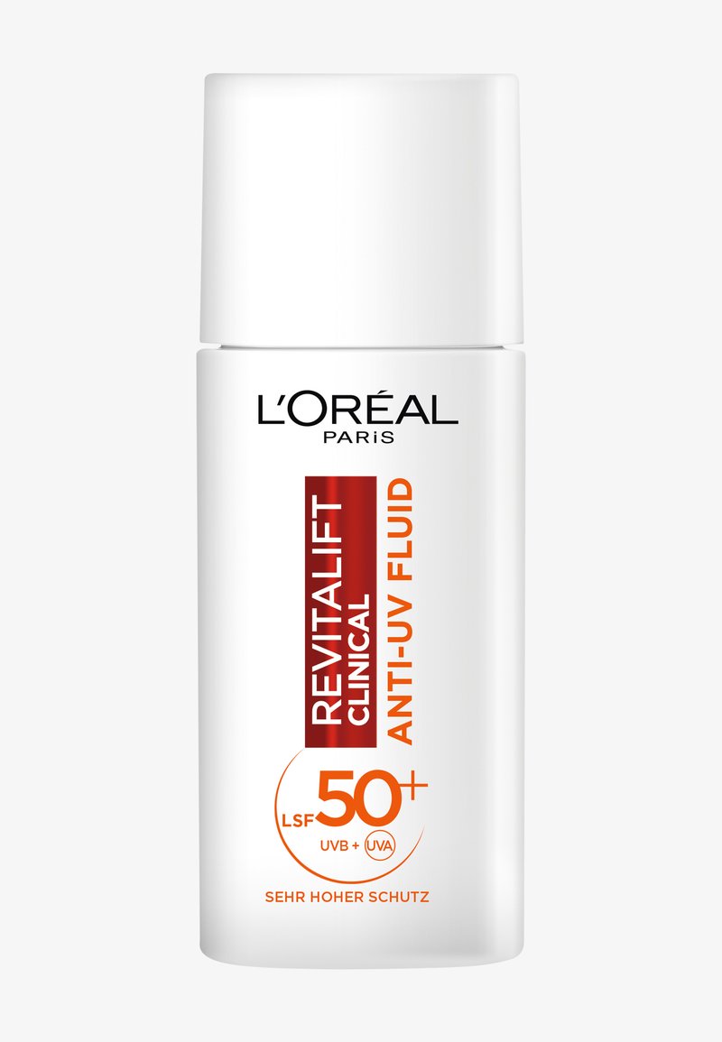 Płyn przeciw UV Revitalift od L'Oréal Paris w cylindrycznej, białej butelce. Posiada pomarańczowy tekst oznaczający SPF 50+, z gładką, błyszczącą powierzchnią.