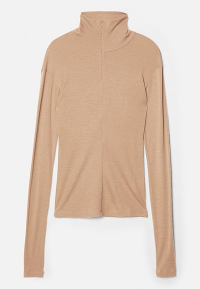 Light beige long-sleeve top with high collar and a back zip, made of a soft, smooth fabric; features a fitted design and straight hem.