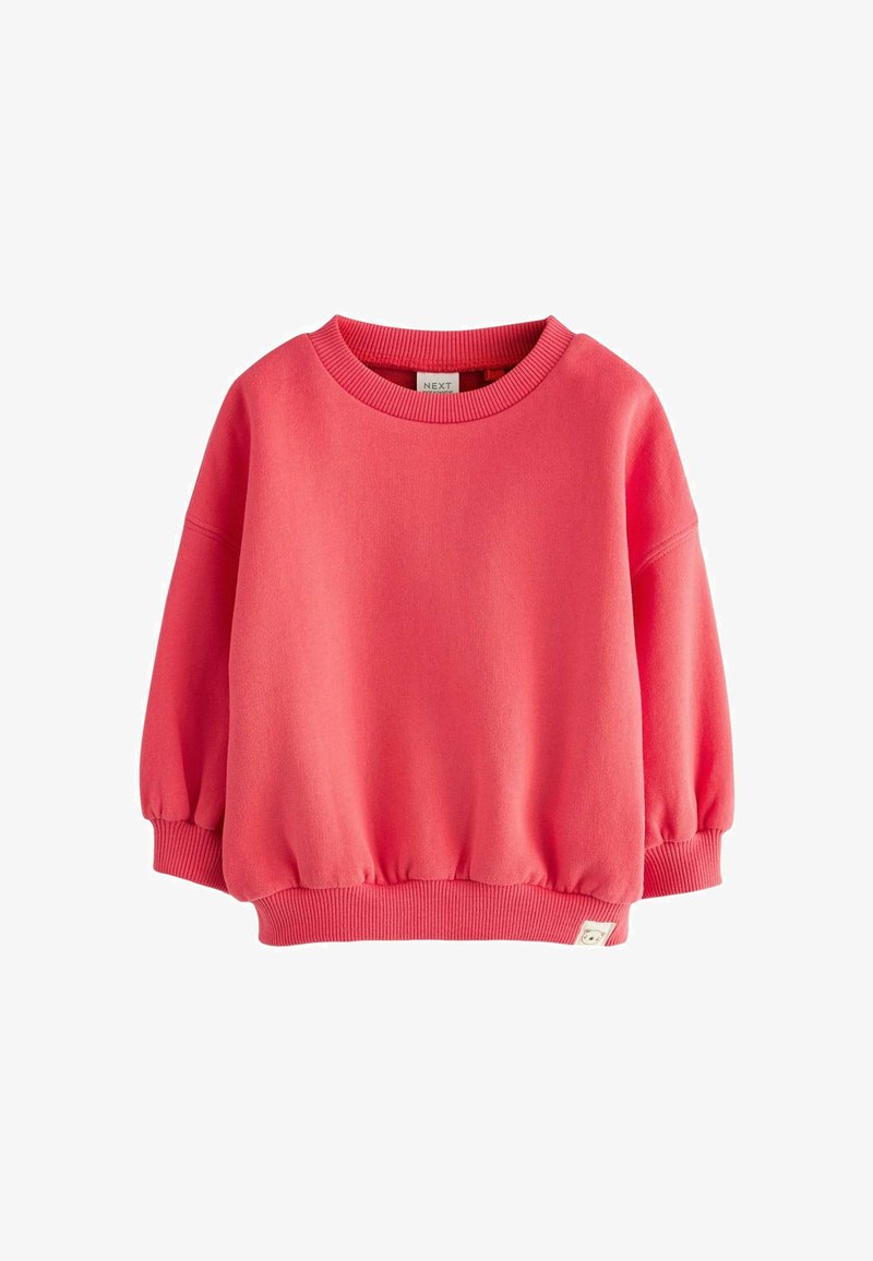 Rosa Sweatshirt mit rundem Halsausschnitt, langen Ärmeln, gerippten Bündchen und Taillenbund. Aus weichem Stoff gefertigt, mit einem kleinen Etikett am Saum.