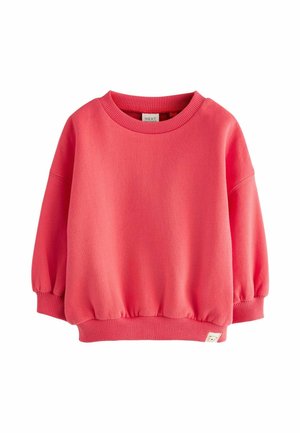 Sudadera rosa con cuello redondo, mangas largas, puños y cinturilla de canalé. Fabricada en un tejido suave, presenta una pequeña etiqueta en el dobladillo.