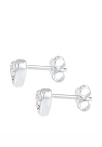 Orecchini a perno in argento con un design arrotondato, caratterizzati da gemme trasparenti al centro. Texture liscia e finitura lucida. Stile classico.