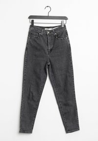 Korkeavyötäröiset mustat farkut, joissa on slim fit -leikkaus, viisi taskua ja hopeiset nappikiinnitykset. Sujuva pinta, minimaalinen kuluminen ja klassinen muotoilu.