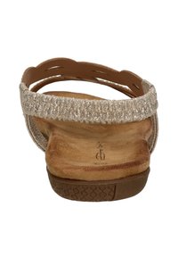 Beige sandal with a textured, glittery upper strap and soft suede footbed. Features a low-profile rubber sole with a patterned tread.