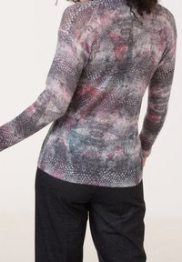 Lightweight, patterned pullover featuring shades of gray, pink, and teal. Textured knit with long sleeves and fitted design.