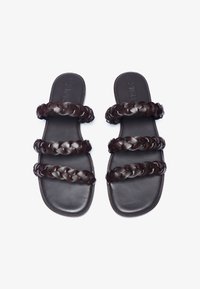 Dark brown leather sandals with three braided straps and flat soles, featuring smooth texture and rounded edges. No visible branding.