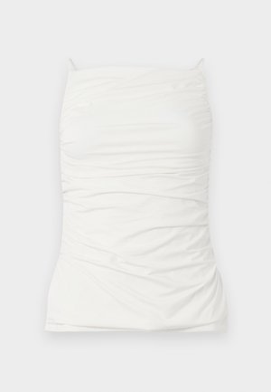 White sleeveless top made of smooth fabric, featuring a fitted silhouette with ruched detailing and adjustable shoulder straps.