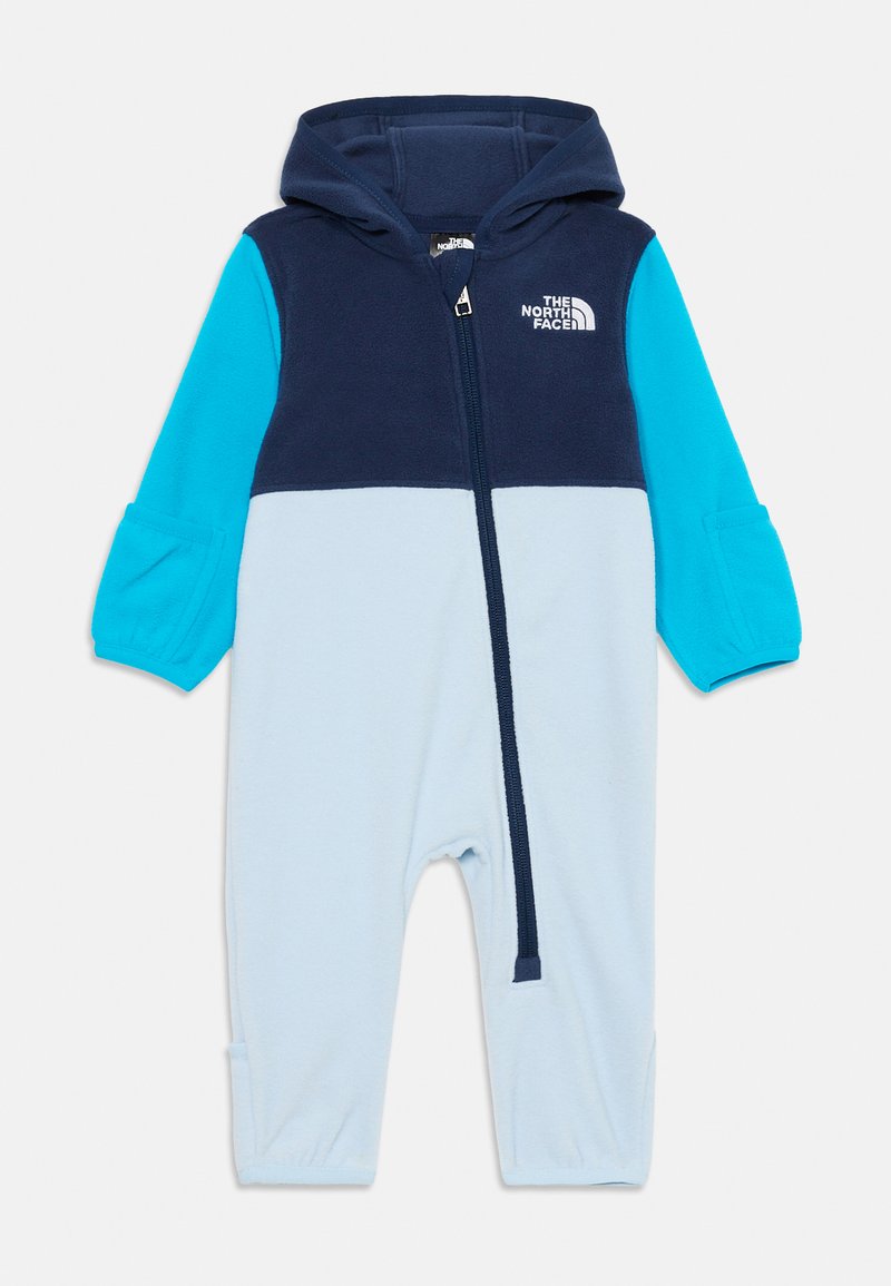 Vaikiškas vienos dalies fliso kostiumėlis su gaubtu, priekiniais užtrauktukais ir spalvotais blokais mėlynos, akvamarino ir šviesiai mėlynos spalvos, ženklintas "The North Face."