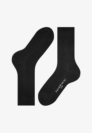 Calzini neri alla caviglia con texture liscia, caratterizzati da punte e talloni rinforzati. Logo stampato sulla suola, design minimalista.