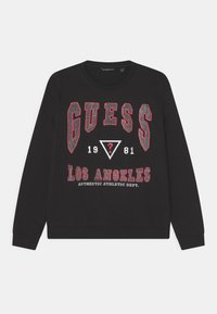 Felpa nera con maniche lunghe, caratterizzata da una scritta "GUESS" in bold rosso e bianco, triangoli e il testo "LOS ANGELES" in dettagli stampati.