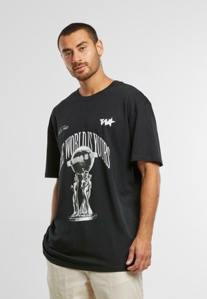 Black unisex oversized t-shirt made of cotton. Features a white graphic print of a globe and figures with "THE WORLD IS YOURS" text.
