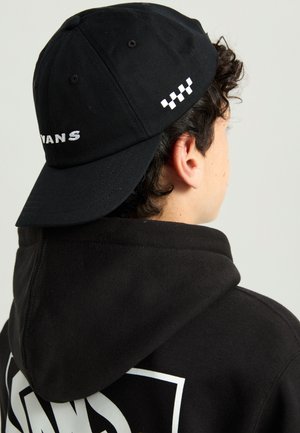 Black cap with a curved brim, featuring "VANS" embroidered in white on the front and a checked pattern accent on the side.