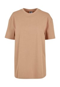 Béžové bavlněné tričko s kulatým výstřihem, krátkým rukávem a volným střihem. Hladký povrch, bez vzoru, s viditelným švem podél spodního okraje.
