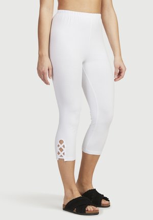 Witte capri leggins hebben een hoge tailleband en een uitsnede-lattice detail aan de zoom. Een zachte, rekbare stof verhoogt het comfort en de pasvorm.