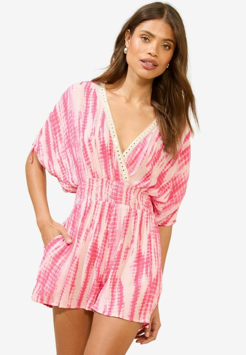 Pink tie-dye romper with a deep V-neck, wide sleeves, elastic waistband, and pockets; features metallic accents along the neckline.