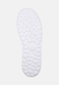White rubber sole featuring a textured surface with multiple round bubble patterns and the embossed brand name "Camper" in the center.