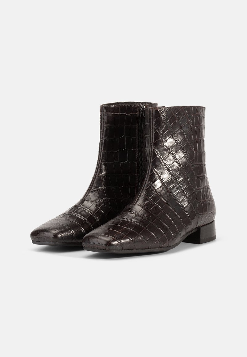 Stivali ankle lucidi di colore marrone scuro con texture di coccodrillo, zip laterale, punta quadrata e tacco basso su uno sfondo bianco.