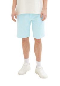 Light blue cotton shorts with a relaxed fit, featuring side pockets and a smooth finish, worn with white sneakers and socks.