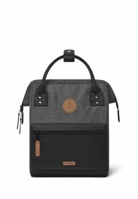 Black and gray backpack with a textured exterior, front zip pocket, two top handles, and a circular logo patch.