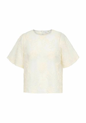 Elfenbensfarvet kortærmet bluse med rund halsudskæring og subtilt blomstret tekstureret stof, lukkes med lynlås bagpå.