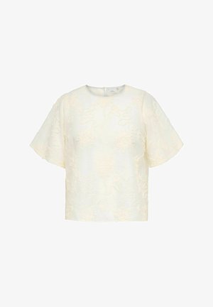 Elfenbensfarvet kortærmet bluse med rund halsudskæring og subtilt blomstret tekstureret stof, lukkes med lynlås bagpå.