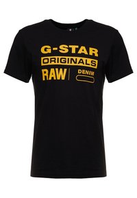 Czarna bawełniana koszulka z odważnym żółtym napisem "G-STAR ORIGINALS RAW DENIM". Okrągły dekolt, krótkie rękawy oraz luźny krój.