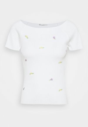 Haut à manches courtes blanc à rayures avec broderies florales en jaune et violet. Doté d'un col rond et d'un design ajusté. Tissu texturé.