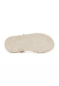Semelle de chaussure avec motif texturé, en matériau en caoutchouc épais et durable de couleur crème claire. Détails de prise avec des indentations profondes.