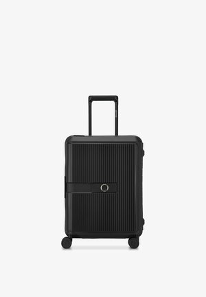 Valise rigide noire avec rainures verticales, poignée rétractable, quatre roues pivotantes et serrure à combinaison intégrée sur le panneau avant.