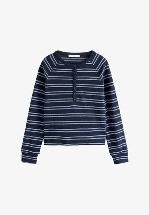 Tumesinise värvi pikkade varrukatega särk, millel on valged horisontaalsed triibud, nööpide rida ja soonikuga mansetid. Pehme kangas ja mugav lõige.