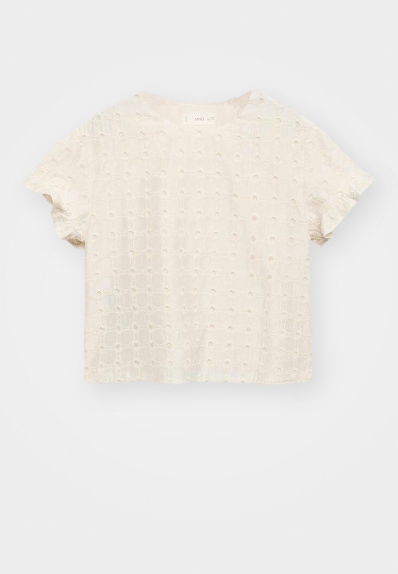 Light cream short-sleeved top made of textured fabric with a patterned design of circular cutouts, featuring a relaxed fit and crew neckline.