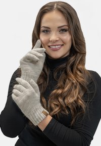 Knitted gloves in light gray, featuring ribbed cuffs and a textured finish. Includes a small leather tag on the wrist.